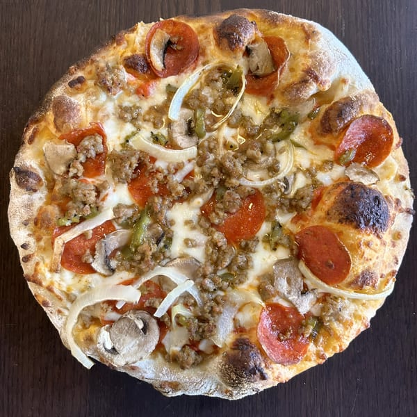 A whole Sid's Pizza with pepperoni, sausage, mushrooms, onions, and green peppers.